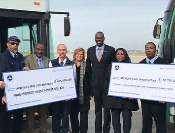 FTA administrators holding checks.