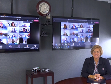 two TVs with video conferencing view on