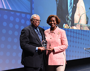 Administrator Nuria Fernandez presents CTA President Dorval Carter with the 2023 Environmental Document Award during the APTA TRANSform conference in October 2023.