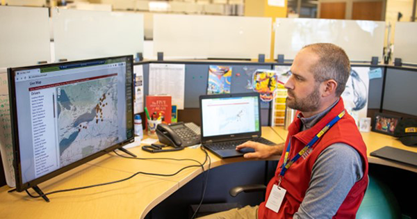Person sitting in front of a computer screen viewing a map. Source: National Aging and Disability Transportation Center Photo Gallery