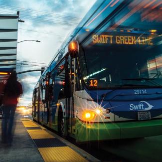 Public bus at a bus stop picking up passengers