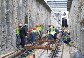 Workers lay new track during construction project