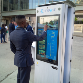 FTA staff trying out a new smart kiosk in Kansas City. Use of this image should not be construed as an endorsement of any applicant or application. Kansas City smart kiosk