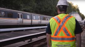 Worker alongside heavy rail tracks