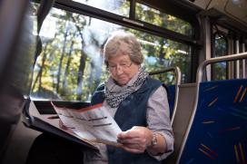 Older adult consults map while on subway